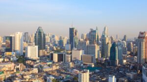 Article 11 Aerial view of Bangkok skyline with modern skyscrapers and traditional Thai buildings, symbolizing the blend of tradition and modernity in Thai property law.