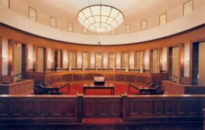 Article 4 A courtroom in Bangkok with a judge presiding over a defamation lawsuit, symbolizing the legal complexities of defamation cases in Thailand.